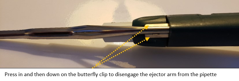 Press in and then down on the butterfly clip to disengage the Rainin ejector arm from the pipette