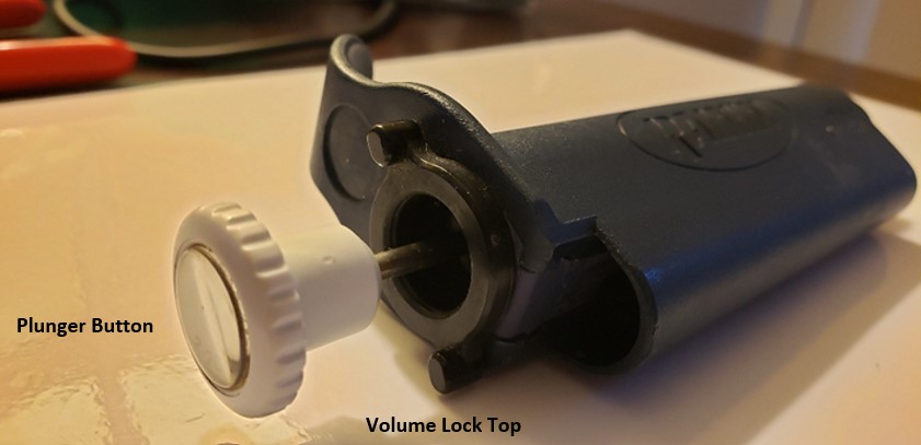 Plunger button and volume lock top