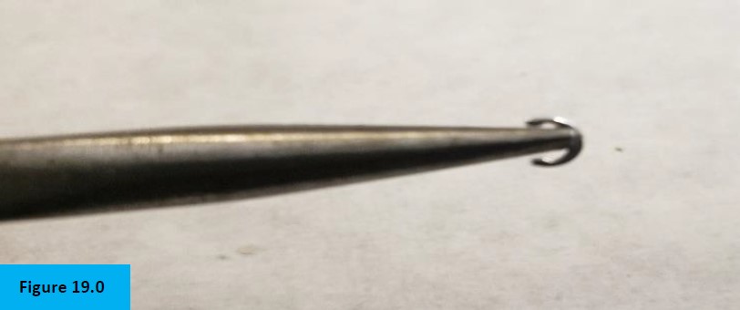 Figure 19.0. Needle nose pliers holding c-clip for installation in tool.