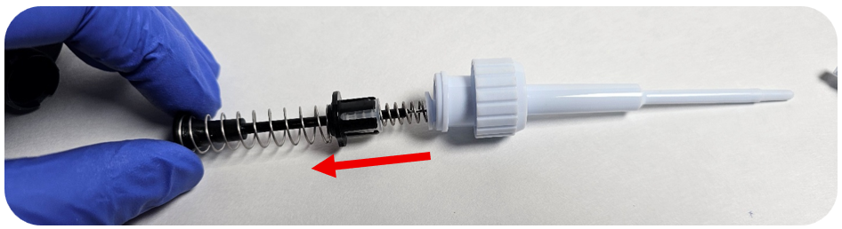 Removing the piston assembly from the Pipetman tip holder.